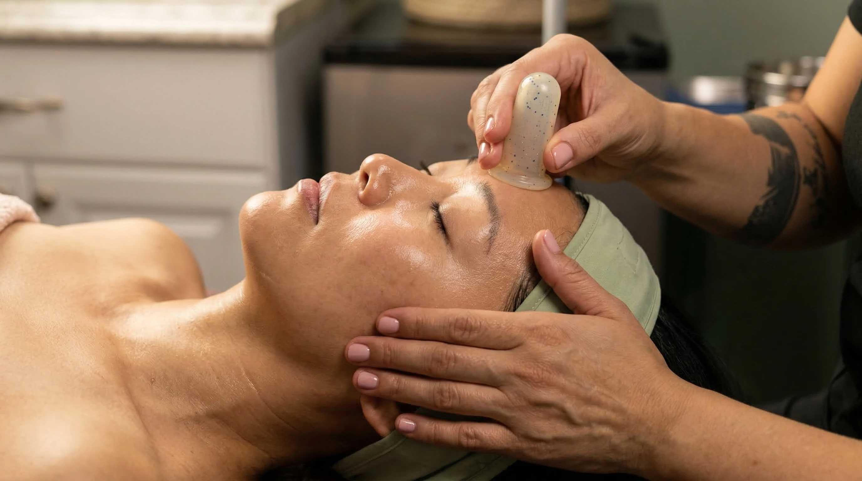 Facial cupping therapy using a small silicone cup on the cheek and jaw area