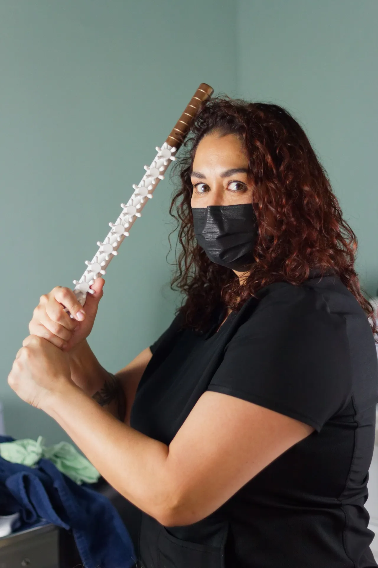 Aiyani holding a FasciaBlaster tool at Central Coast Red Coral Spa